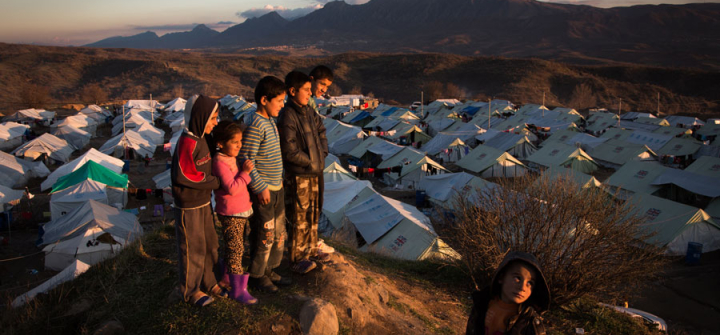 Children look out at the sunset over the Bamarne IDP camp in northern Iraq.