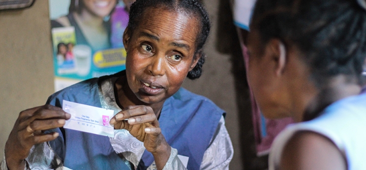 Community Health Volunteer in a remote village of Tulear, Madagascar, giving instructions to a client on the use of pregnancy tests. 