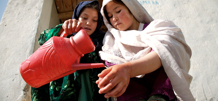 Two Girls with a Water Can