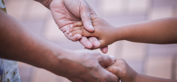 Grandmother and child holding hands; Thailand