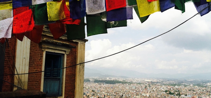 Prayer flags fluttering above Nepal. Image Courtesy of Emaline Laney.