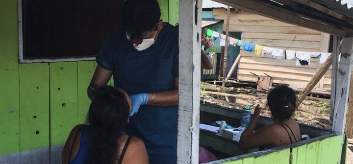 Marco Alarcon, DDS, MS, conducts an oral examination in Peru's impoverished Claverito settlement. 