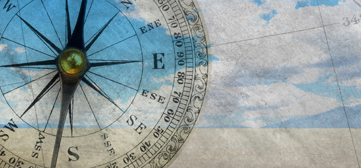 Graphic composition of a compass over sky