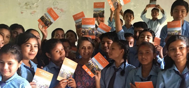 Physician-advocate Rita Thapa shares a booklet on cardiovascular disease risk factors with friends at a secondary school in Dang, Nepal on August 24, 2018. (Image courtesy)