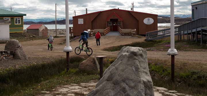 Children play outside the Elder's Qammaq in downtown Iqaluit, Nunavut.