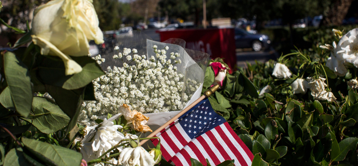 A makeshift memorial honors gun violence victims in Thousand Oaks, Calif., a city that’s currently threatened by raging wildfires. Image: Apu Gomes/AFP/Getty Images