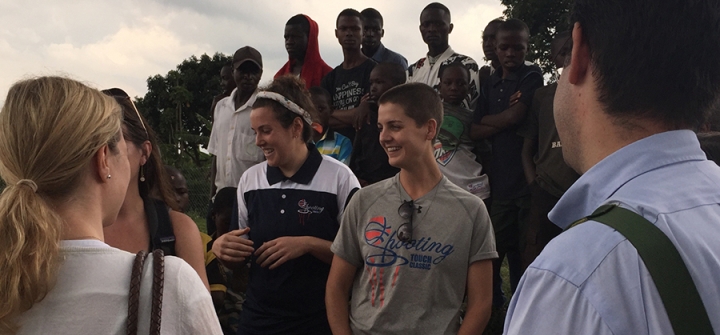 Shooting Touch's Chloe Rothman (center left) and Lisanne Comeau (center right) describe their program to ICFP delegates on a site visit to the Nyamirama health center in Rwanda.