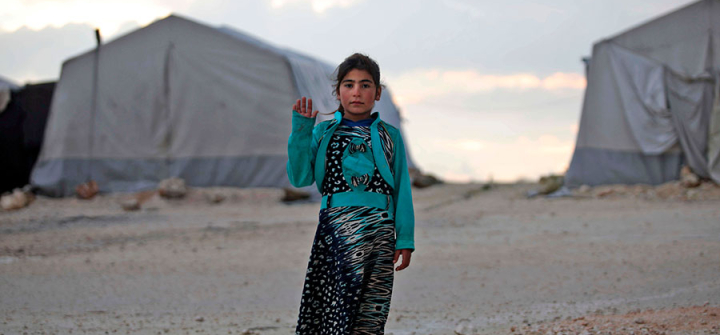 A displaced Syrian girl waves to theA Syrian girl waves to the camera at a camp in Kafr Lusin near the border with Turkey in Idlib province in northwestern Syria on Feb. 17, 2019. Image: Aaref Wata/AFP/Getty  camera at a camp in Kafr Lusin near the border with Turkey in Idlib province in northwestern Syria on February 17, 2019. (Photo by Aaref WATAD / AFP) (Photo credit should read AAREF WATAD/AFP/Getty Images)