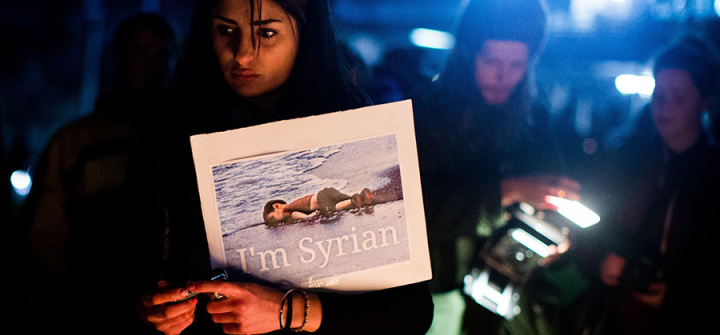 Australians stand in solidarity with refugees in honour of Aylan Kurdi MELBOURNE , AUSTRALIA - SEPTEMBER 07: A woman holds a sign during a candle light vigil in honour of Syrian refugee Aylan Kurdi and in protest against the Australian government's position on refugees and asylum seekers on September 07, 2015, in Melbourne, Australia. 