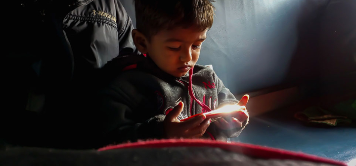 A child watches videos on a mobile device in Burhanpur, India. © 2019 Danish Mansuri, Image Courtesy of Photoshare