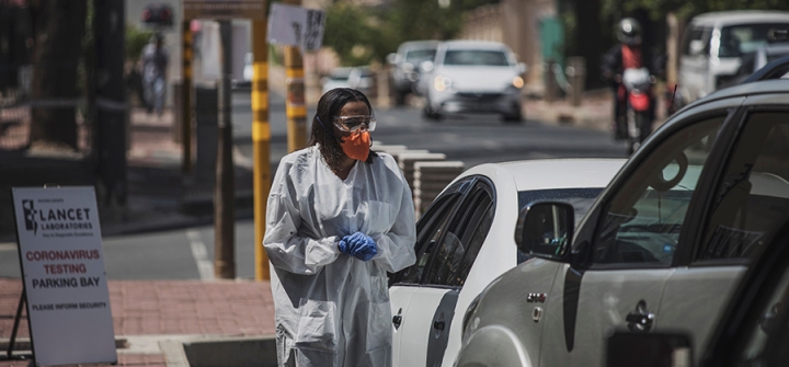 A health worker conducts drive-through novel coronavirus testing in Johannesburg yesterday. Photo: Marco Longari/AFP via Getty Images