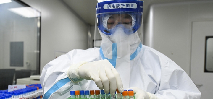 A medical worker handles samples for nucleic acid test at Weishi Medical Laboratory on March 4 in Changsha, China.