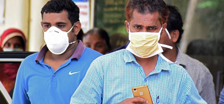 Indian residents wear face mask outside the Medical College hospital in Kerala, India on May 21, 2018, during a Nipah virus outbreak. Image: AFP via Getty