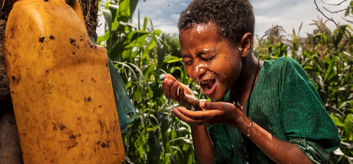 Fantanesh Gedefe, in Ethiopia’s Amhara Region, washes her face from water stored in the “leaky tin.” Facial cleanliness is an integral component of the SAFE strategy for trachoma elimination. Brent Stirton/Getty Images Courtesy of the International Trachoma Initiative.