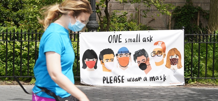  A person walks by a sign that reads "One small ask, please wear a mask." New York City, May 27, 2020.   Image: Rob Kim/Getty