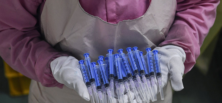 A worker displays syringes at the Hindustan Syringes factory in Faridabad as India ramped up production ahead of a coronavirus vaccine rollout. September 2, 2020 Image: Sajjad Hussain/AFP/Getty