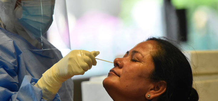 A Nepalese health worker takes a nasal swab of a parliamentary lawmaker for a coronavirus PCR test in  Kathmandu on May 5. Image: Narayan Maharjan/NurPhoto via Getty