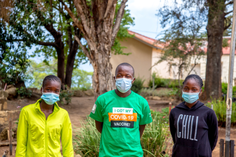 sther Sambiri, left, stands with fellow vaccine advocates outside the Nyanga, Zimbabwe, district government office on Dec. 16, 2021. Image: Farai Mutsaka