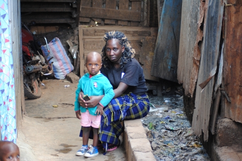 Mary Ndira sist outside their house next to a drainage in Kibera slums on March 2, 2022 Photo-Dominic Kiruli