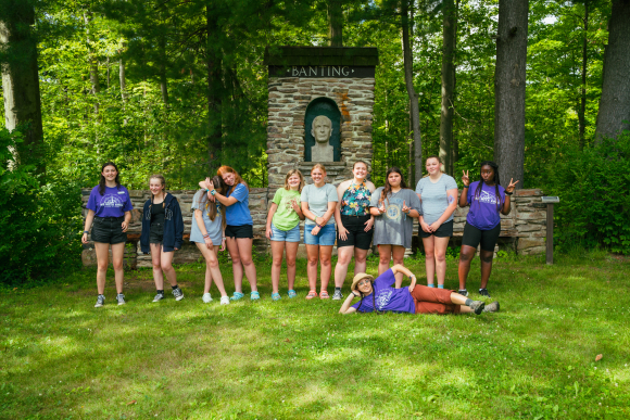 A group of 11 teen girls pose at Camp Ho Mita Koda