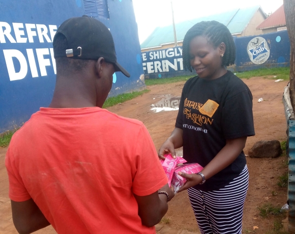 A health worker distributes condoms at a truck stop.
