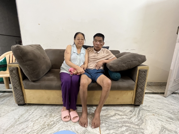 Moinu Valte sits with her husband Vungzagin Valte, a Manipur politician, who was attacked by a mob in May 2023. Cheena Kapoor