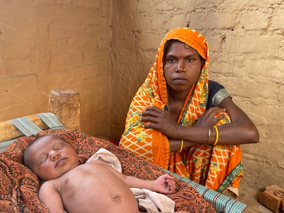 A woman sits with her baby in a hut near brick kiln in Rajasthan’s Bhilwara district.