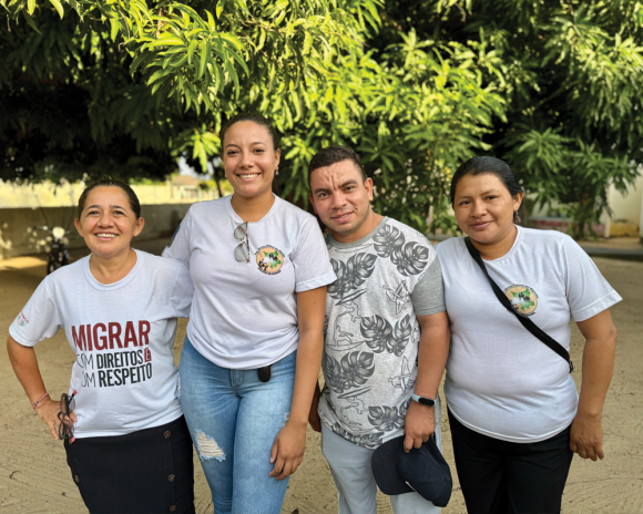 Sister Valdelice Gomes, far left, smiles with a group of volunteers in the churchyard in Bonfim.