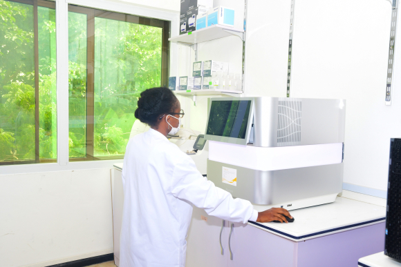 A researcher from the  West African Centre for Cell Biology of Infectious Pathogens runs a genome sequencer at their laboratory.