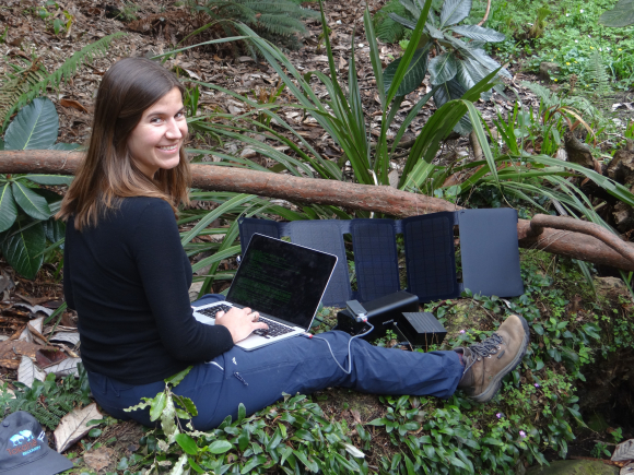 Lara Urban runs a genome sequencer in the field. 