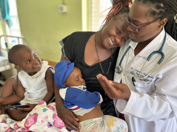 Catherine Nabaggala, MD, consoles Olivia Nansamba whose son Melvin had a blood transfusion to treat sickle cell anemia. Joanne Cavanaugh Simpson