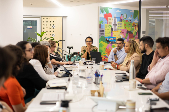 Vital Strategies CEO Mary-Ann Etiebet confers with colleagues in Brazil in October 2025.