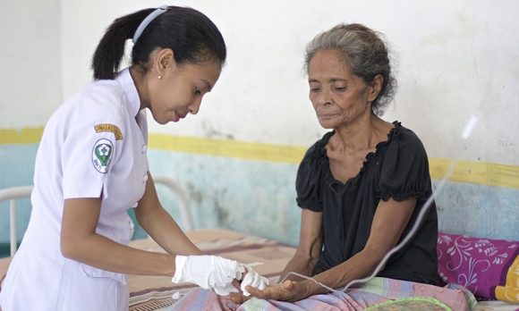 Fransura Kavori recovers from an attack of Plasmodium falciparum malaria at the Mebung Primary Health Centre at remote Alor Island in eastern Indonesia and her nurse, Dian Adiana. ©Pearl Gan in association with Oxford University Clinical Research Unit , Eijkman Oxford University Clinical Research Unit and  The Wellcome Trust.