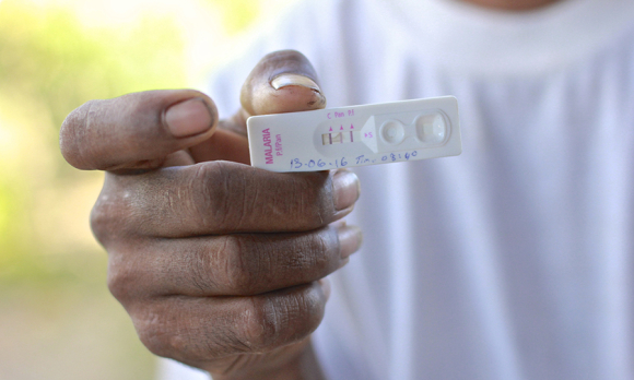 A malaria patient reading his blood test result. ©Pearl Gan in association with Oxford University Clinical Research Unit, Eijkman Oxford University Clinical Research Unit and The Wellcome Trust.