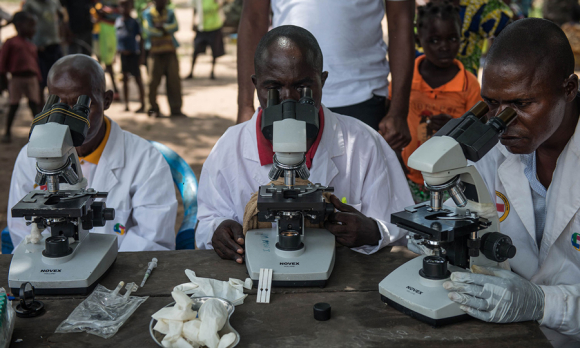 scientists looking through microscopes