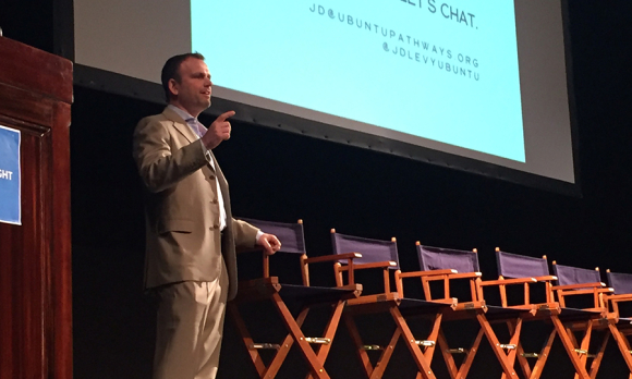 Jordan Levy delivering rousing opening plenary remarks at Unite for Sight's 15th Annual Global Health and Innovation Conference on April 14, 2018, on the stage of New Haven's Shubert Theater.