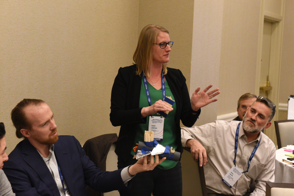 Cassandra Crifasi shows off a “coffee cup drone” she and others created during Thursday's design challenge hosted by the Center for Social Design at the Maryland Institute College of Art. (Image: Larry Canner)