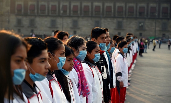 A group of students wear face masks to protect from air pollution during a ceremony at Zocalo Square in Mexico City on May 17, 2019. Alfredo Estrella/AFP/Getty Images)