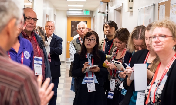 #AHCJ2019 Journalists listening to Marcelo Jacobs-Lorena during a tour of the Johns Hopkins Malaria Research Institute insectary. Image by Larry Canner.